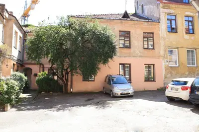 a car parked in a parking lot in front of a building at Town Hall Square Apartments in Vilnius