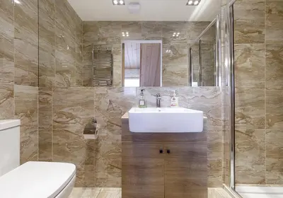 a bathroom with a white sink and a shower at Prie Lukos ezero in Trakai