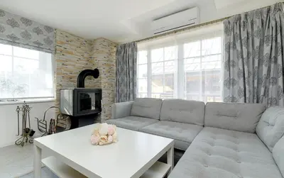 a living room with a couch and a table at Prie Lukos ezero in Trakai