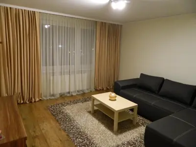 a living room with a couch and a coffee table at Apartamentai in Marijampolė
