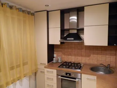 a kitchen with a sink and a stove top oven at Apartamentai in Marijampolė