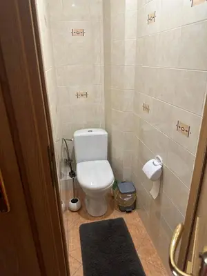 a bathroom with a white toilet in a room at Apartamentai in Marijampolė