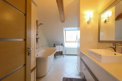 a bathroom with a tub and a sink and a mirror at Central Hotel Radviliškis in Radviliškis