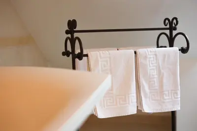 a group of towels hanging on a towel rack at Central Hotel Radviliškis in Radviliškis