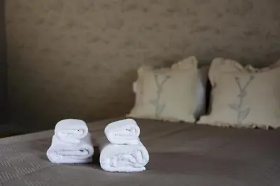 a pair of towels sitting on a bed at Central Hotel Radviliškis in Radviliškis