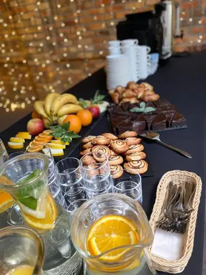 a table with a bunch of food and drinks at Central Hotel Radviliškis in Radviliškis