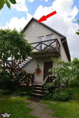 a house with a balcony on top of it at Apartment 5A in Kaunas