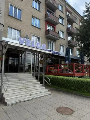 a building with a sign on the front of it at Velga in Vilnius