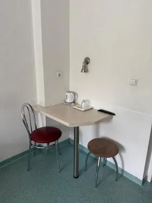 a table and two chairs in a room at Velga in Vilnius