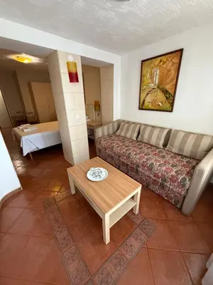 a living room with a couch and a coffee table at Velga in Vilnius