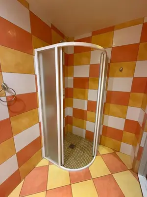 a shower with a glass door in a bathroom at Velga in Vilnius