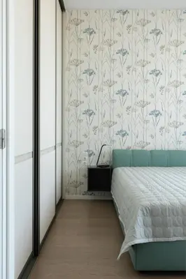 a bedroom with a bed and a floral wallpaper at Korio Apartments, Druskininkai in Druskininkai