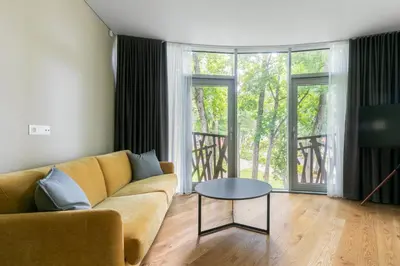 a living room with a couch and a table at Korio Apartments, Druskininkai in Druskininkai