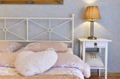 a bedroom with two beds and a lamp on a table at 2 kambarių apartamentai su virtuve, Trakų miesto centre in Trakai