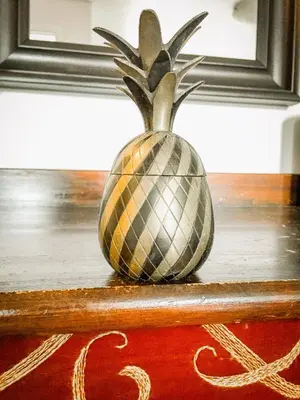 a vase with a pineapple sitting on top of a table at Apartment in the City center in Druskininkai