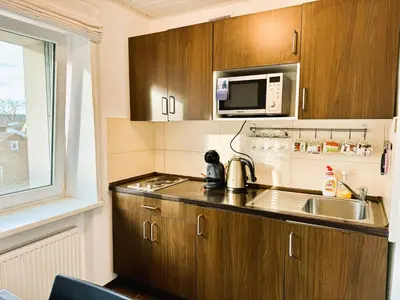 a small kitchen with a sink and a microwave at Apartment in the City center in Druskininkai