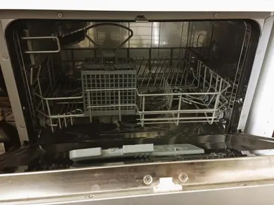 a dishwasher with its dishes inside of it at Apartment in the City center in Druskininkai