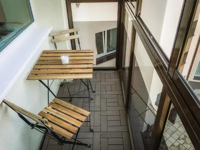 a bench and a cup on a table in a room at Apartment in the City center in Druskininkai