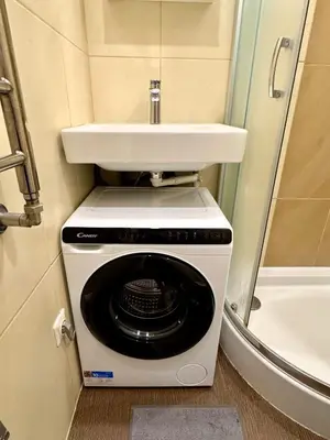 a washing machine and a sink in a bathroom at Apartment in the City center in Druskininkai