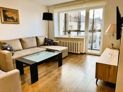 a living room with a couch and a coffee table at Apartment in the City center in Druskininkai