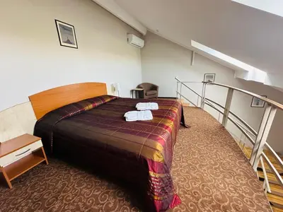 a hotel room with a bed with towels on it at Šiauliu Krasto Medžiotojų Užeiga in Šiauliai