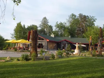 a building with a lawn in front of it at Hotel Green Smiltynė in Panevėžys