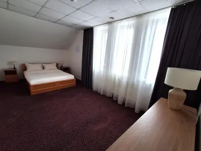 a bedroom with a bed and a large window at Turnė in Šiauliai