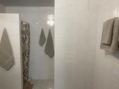 a bathroom with a shower with a glass door at Turnė in Šiauliai