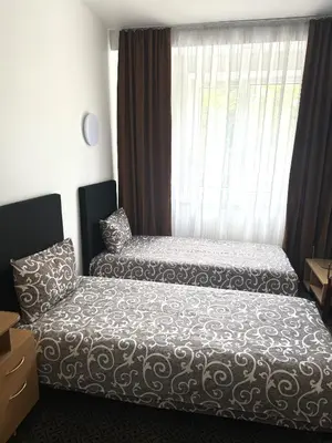 a bedroom with two beds in front of a window at Turnė in Šiauliai