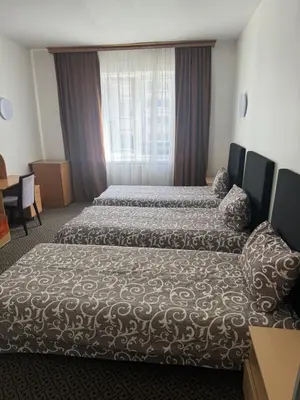 a hotel room with two beds and a window at Turnė in Šiauliai
