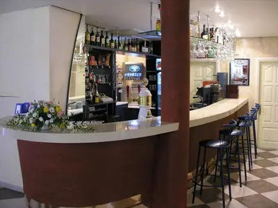 a bar in a restaurant with stools at Turnė in Šiauliai