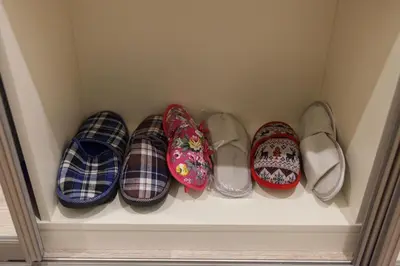 a row of shoes on a shelf in a closet at M.K. Apartments in Vilnius