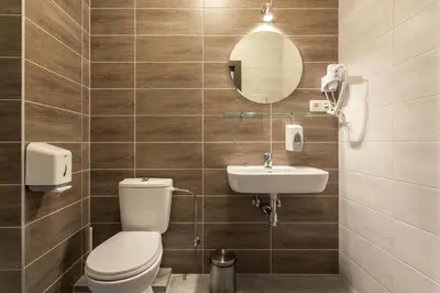 a bathroom with a toilet and a sink at Old Town Trio Hostel Rooms in Vilnius
