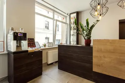 a room with a counter with a coffee machine in it at Old Town Trio Hostel Rooms in Vilnius