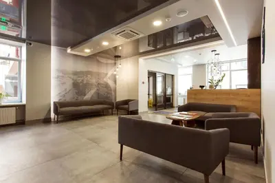a living room with a couch and a table and chairs at Old Town Trio Hostel Rooms in Vilnius