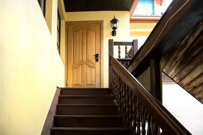 a set of stairs with a wooden door at Skapas Street Vilnius in Vilnius