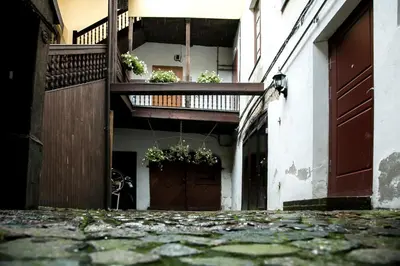 a building with a balcony with potted plants on it at Skapas Street Vilnius in Vilnius