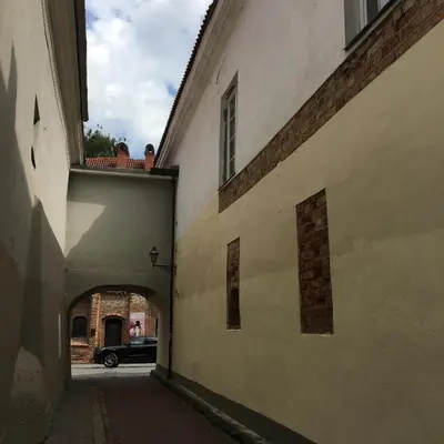 an alley with a car parked in a building at Skapas Street Vilnius in Vilnius