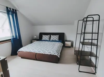 a bedroom with a bed and a ladder in it at K-Town - Apartment near the Lake in Kaunas