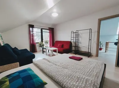a living room with a bed and a couch at K-Town - Apartment near the Lake in Kaunas
