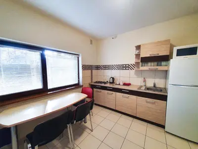a kitchen with a table and chairs and a refrigerator at K-Town - Apartment near the Lake in Kaunas