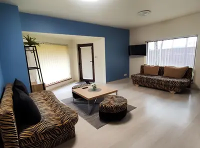 a living room with a couch and a table at K-Town - Apartment near the Lake in Kaunas