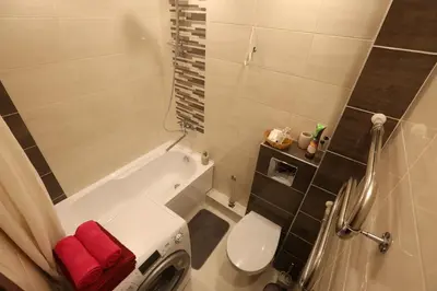 a bathroom with a white tub and a toilet at Modern 2 Rooms Apartment in Kaunas
