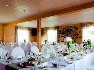 a dining room with white tables and white chairs at Homestead Sartakampis in Gipenai