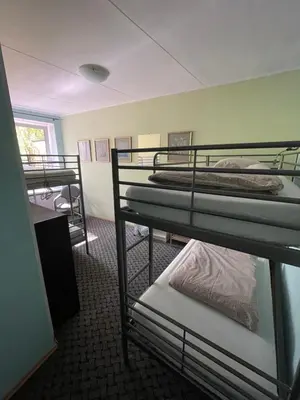a room with several bunk beds in a building at Mikalo House in Vilnius