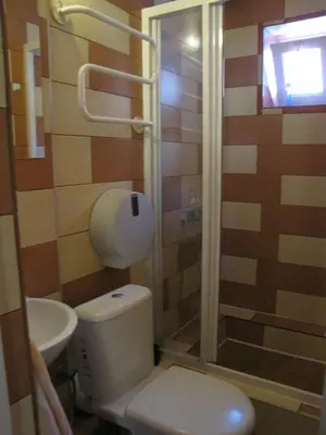 a bathroom with a toilet and a shower and a sink at Mikalo House in Vilnius