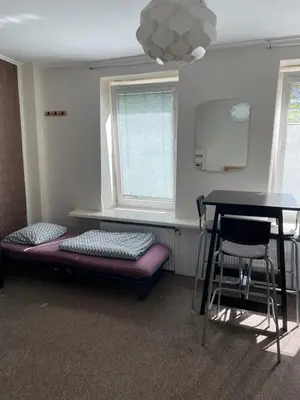 a room with a table and a table and chairs at Mikalo House in Vilnius