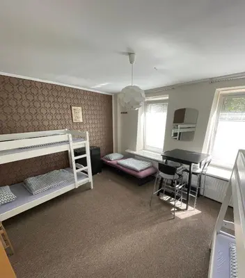 a dorm room with bunk beds and a desk at Mikalo House in Vilnius