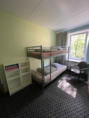 a room with two bunk beds and a window at Mikalo House in Vilnius