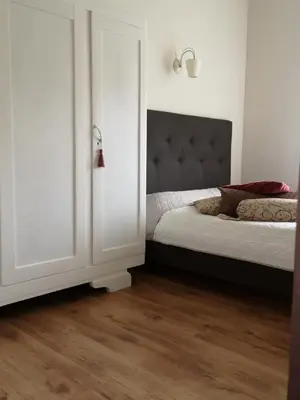 a bedroom with a bed and a white door at Jaukus butas Šiaulių miesto centre in Šiauliai